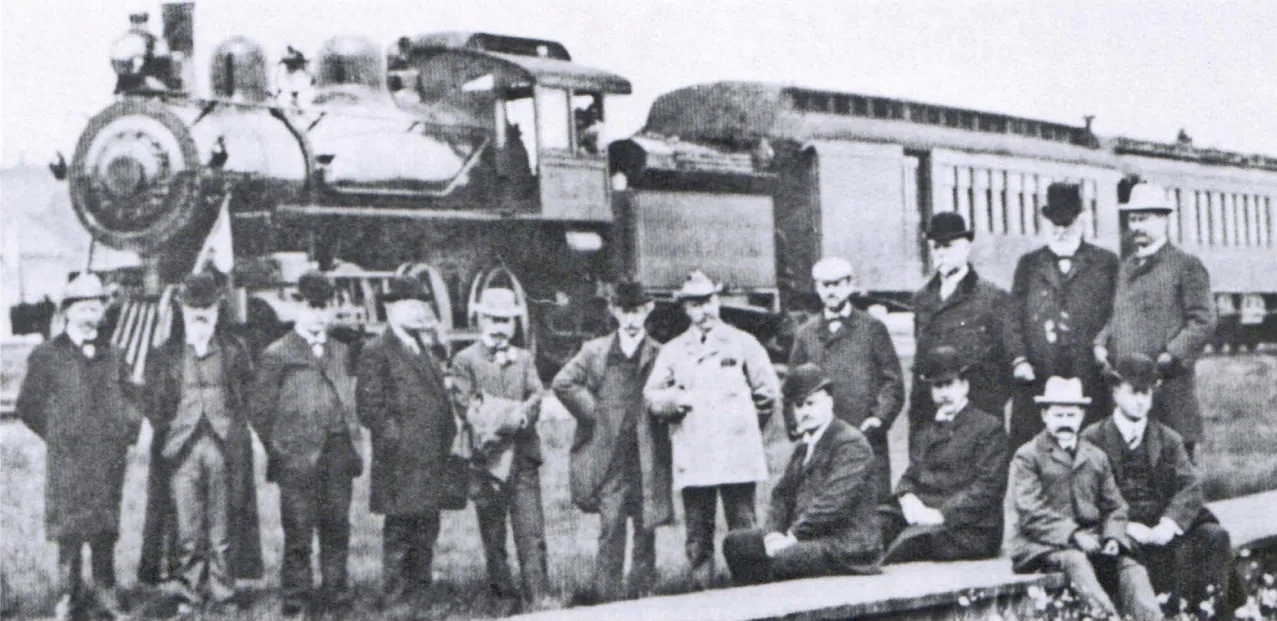 U.S. Steel directors and railroad officers posing in front of a locomotive at Ely in 1901