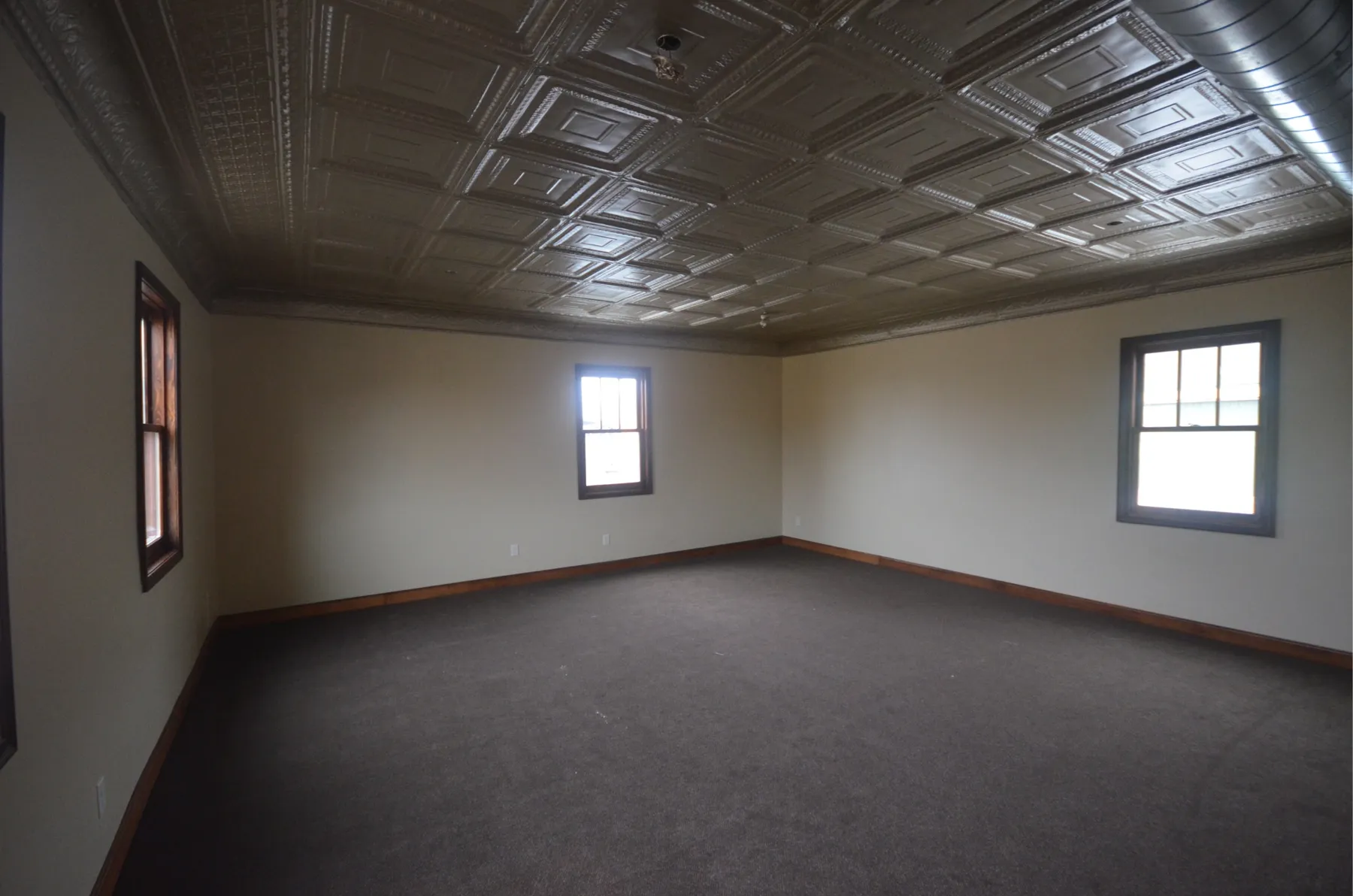 An upstairs office with a pressed tin ceiling