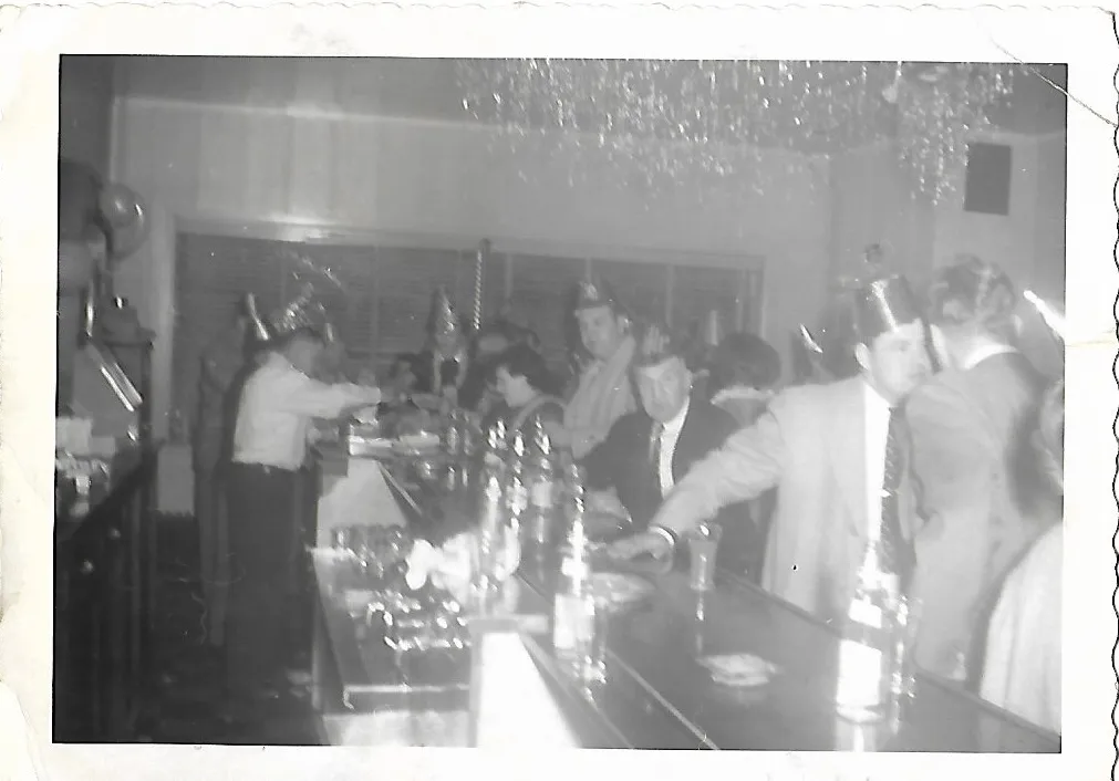 A New Year's Eve party at the bar with paper hats and tinsel hanging from the ceiling