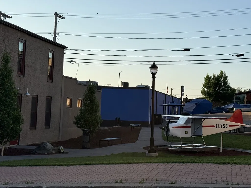 The floatplane and lamp post at dusk from the brick sidewalk