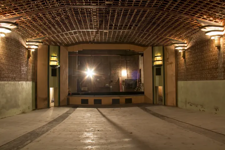 The cleared auditorium lit by Art Deco fixtures, looking toward the stage