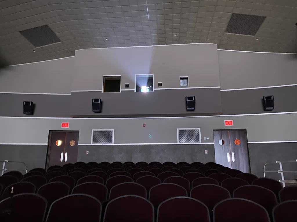 Seats facing the back wall with the projection booth windows and exit doors