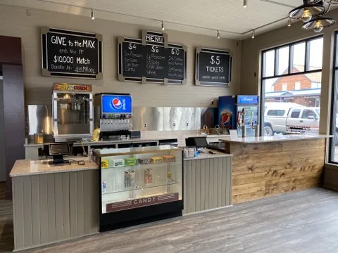 The new concessions counter with popcorn machine, candy case and chalkboard menus