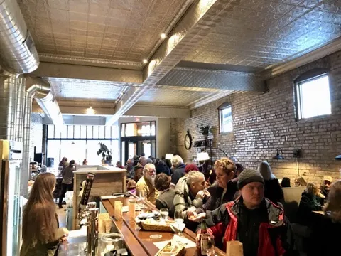 A crowd gathered at the bar under the tin ceiling